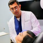 Dr. Joseph preparing to perform surgery on patient in chair