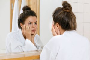 Woman checking dark circles worried about anemia