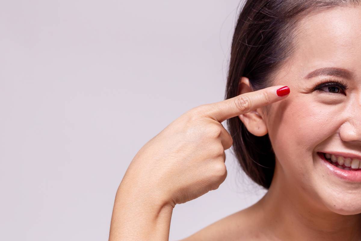 concept image of woman pointing at eyelid crease surgery results