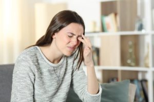 Woman experiencing dry eyes and itchiness